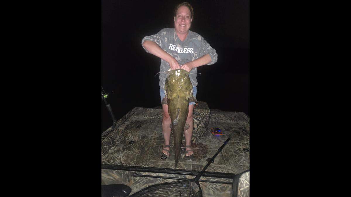 Brandi Holt, of Homedale, holds the 44-inch flathead catfish she caught on the Snake River. The fish set a state catch-and-release record – a record previously held by Brandi’s husband, Jared.