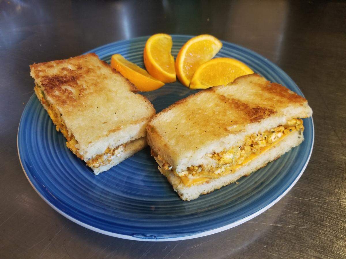 Breakfast Sandwich ($9.75): avocado, seasoned and scrambled tofu, Good Planet vegan cheddar and rosemary black pepper aioli on homemade bread.