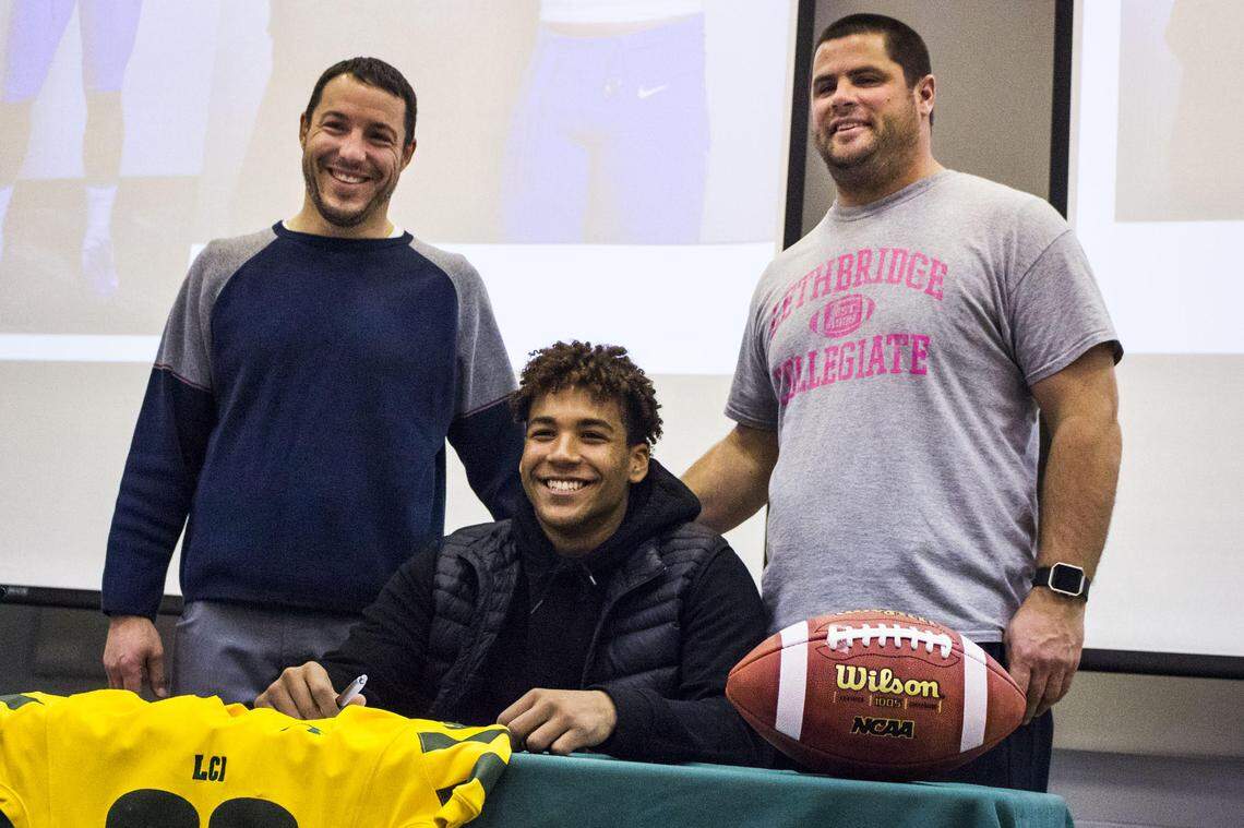 LCI’s Isaiah Bagnah, posing for a photo with vice-principal and athletic director Gordon Vatcher and Rams head coach Darren Majeran, is looking forward to playing NCAA football at Boise State.