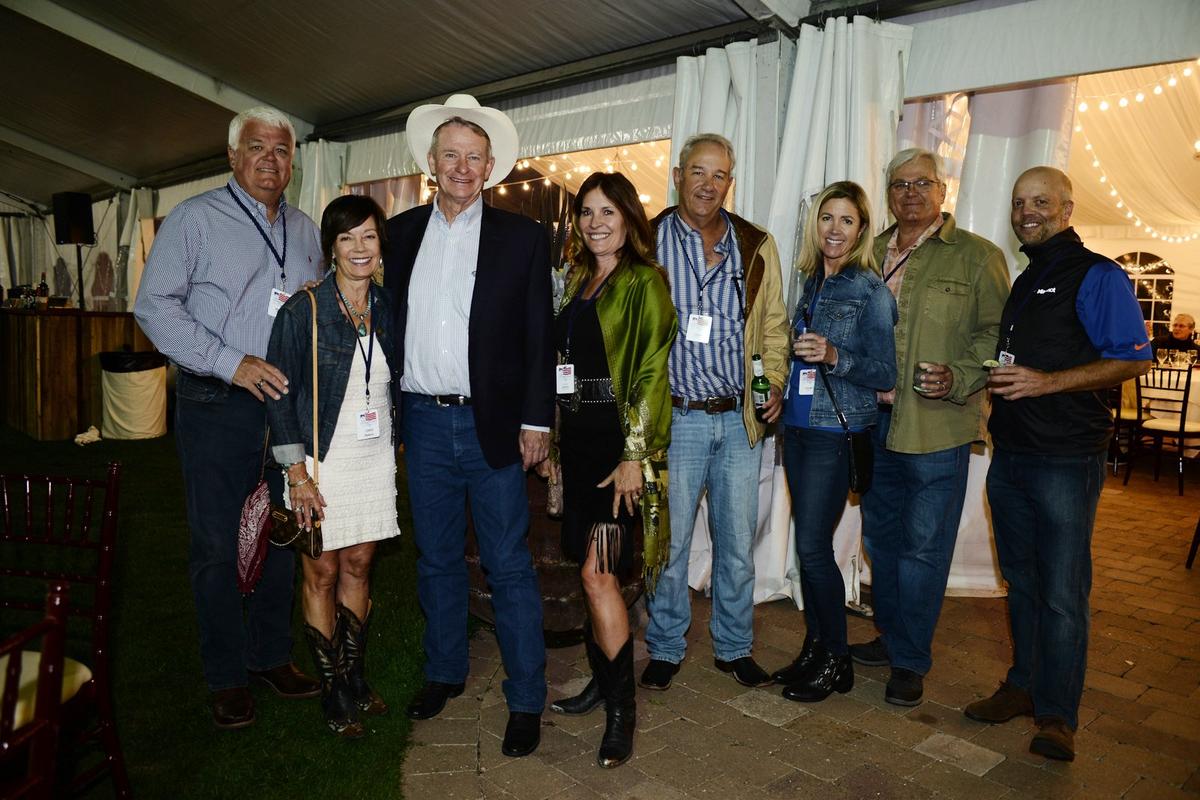 Idaho Gov. Brad Little and Lt. Gov. Janice McGeachin, third and fourth from left, pose for a portrait with other attendees of the Idaho Governor’s Cup during a barbecue dinner event in Sun Valley.