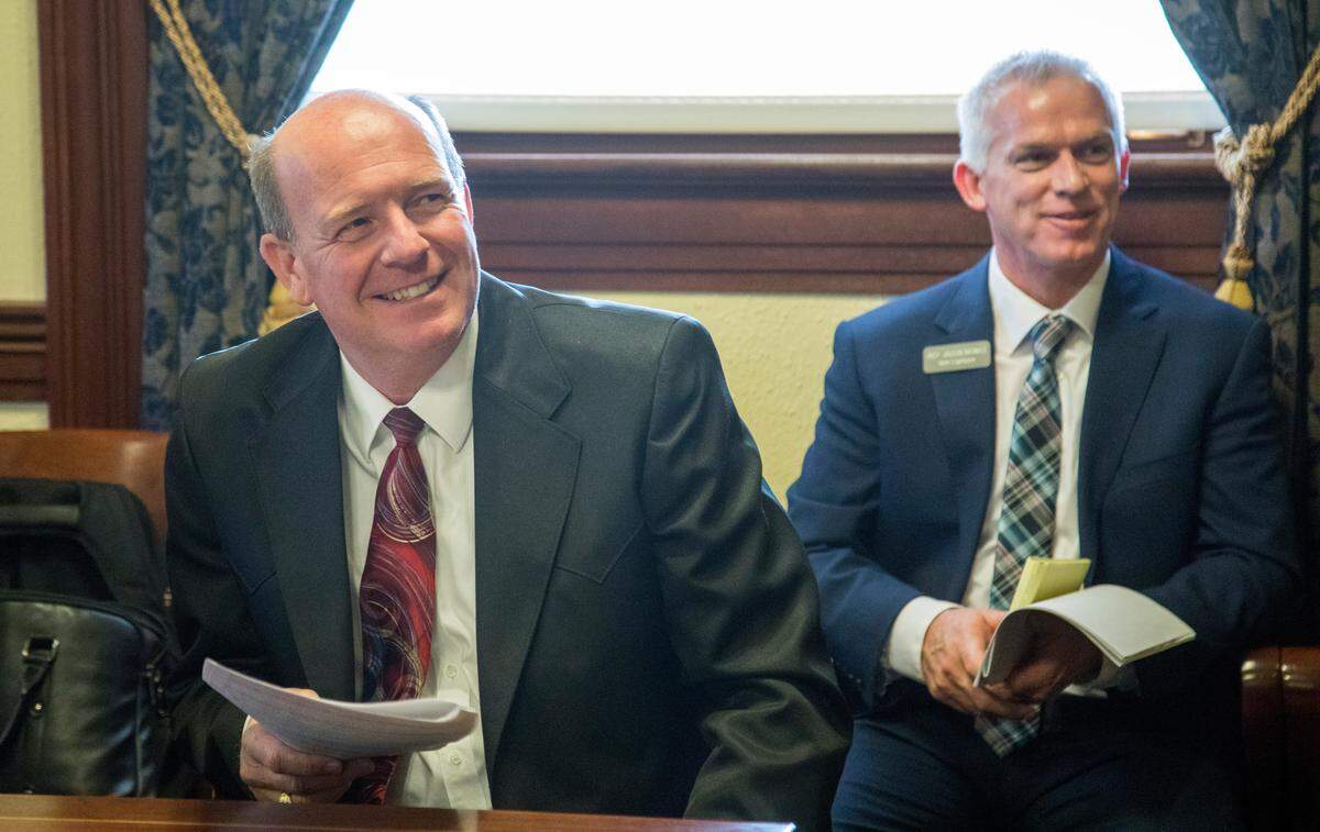 House majority leader Mike Moyle, left, and Jason Monks, assistant majority leader, listen to Gov. Brad Little’s inaugural State of the State address on Jan. 7. Moyle introduced the bill to require public votes on municipal buildings and stadiums receiving urban renewal money.