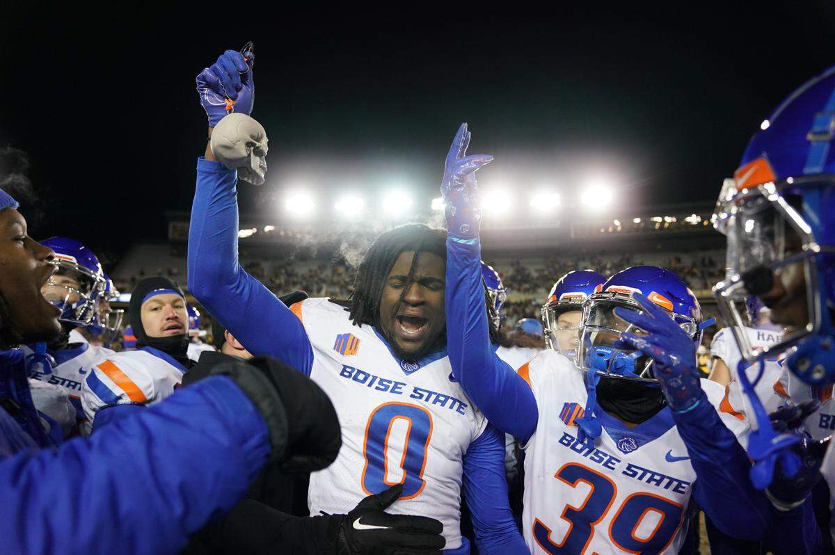 Boise State safety JL Skinner celebrates with a turnover skull after one of his two interceptions in the final minutes of the Broncos’ 20-17 win at Wyoming on Saturday.