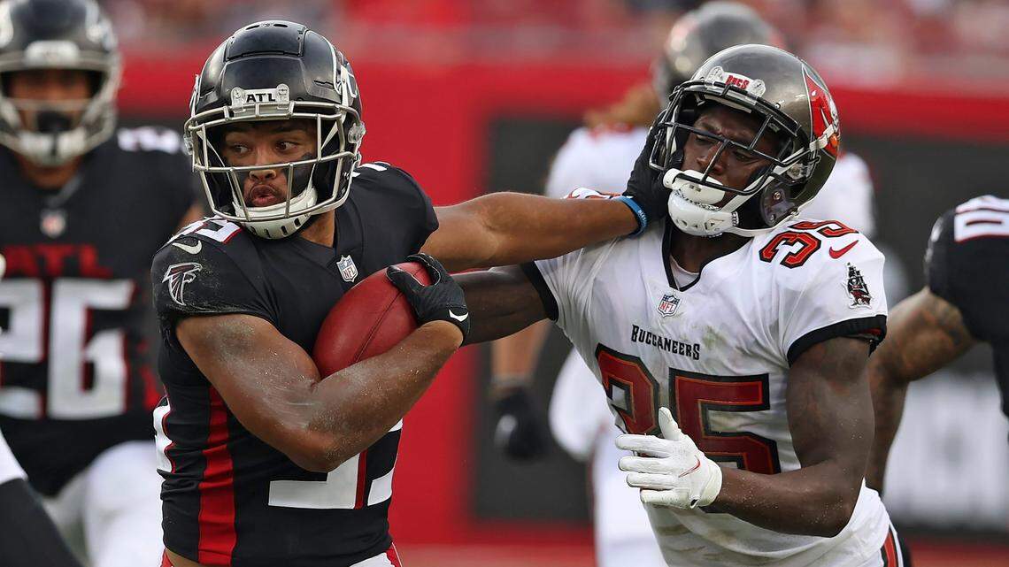 Atlanta Falcons’ Avery Williams, left, stiff arms Tampa Bay Buccaneers defensive back Jamel Dean on a punt return during the second half of their game Sunday in Tampa, Florida.