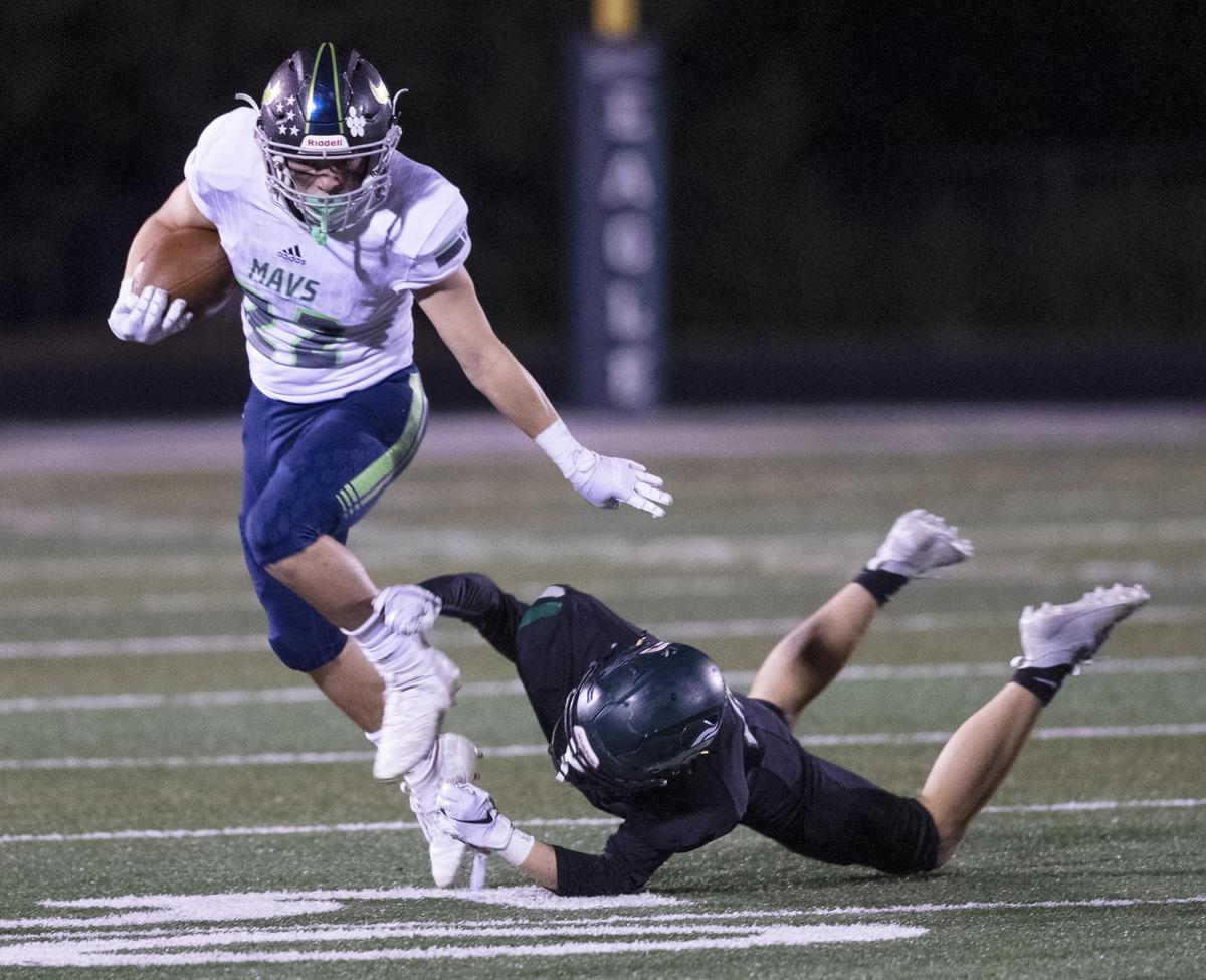 Mountain View running back Steven Butler gains a first down on a big run defended by Eagle’s Gannon Matthews Friday, Sept. 27, 2019 at Eagle High School.
