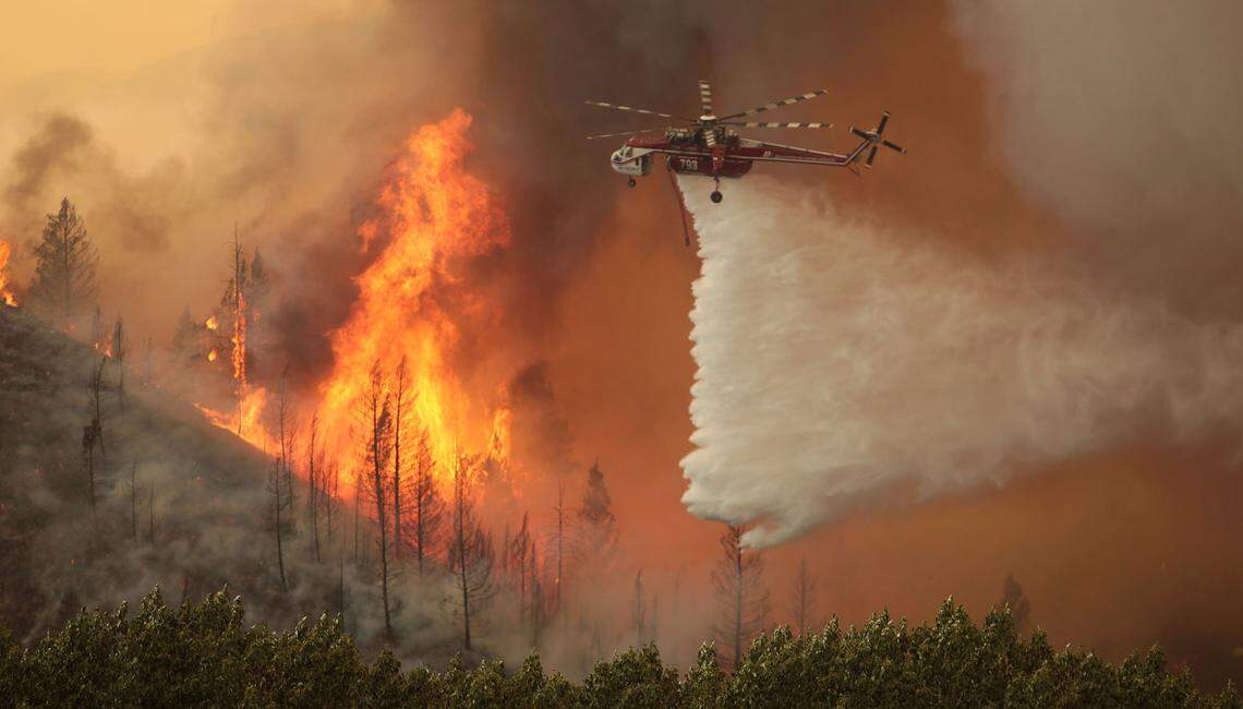 Helicopters battle the 64,000-acre Beaver Creek Fire in August 2013 north of Hailey. Dozens of giant fires over the last 25 years have become more catastrophic because of warming caused by climate change.
