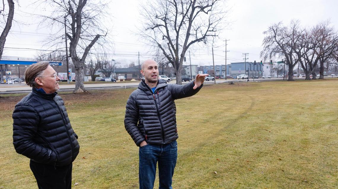 Mark Johnson, a communications liaison, and Trever Nicoll, at right, describe the redevelopment plan in 2023.