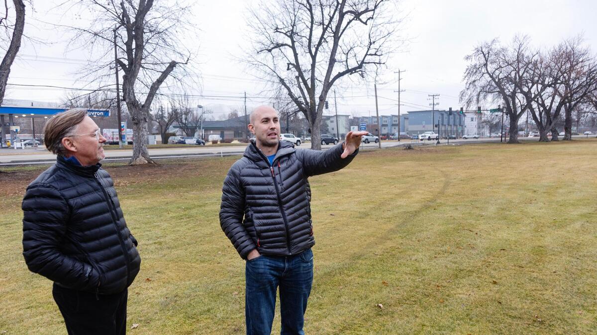 Mark Johnson, a communications liaison, and Trever Nicoll, at right, describe the redevelopment plan in 2023.