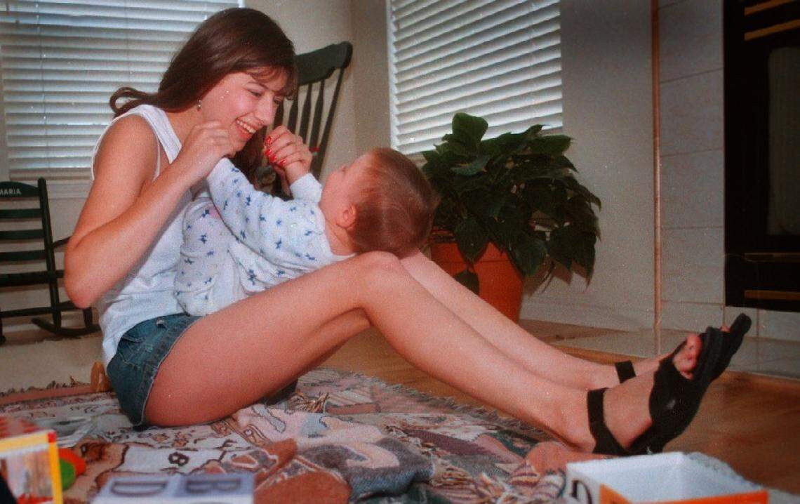 In this Statesman archive photo from 1997, Elizabeth “Lizzi” Barchas rocks 7-month-old Paul Kennedy. Barchas watches Paul and his sister Maria 20 hours a week or more during the summer.