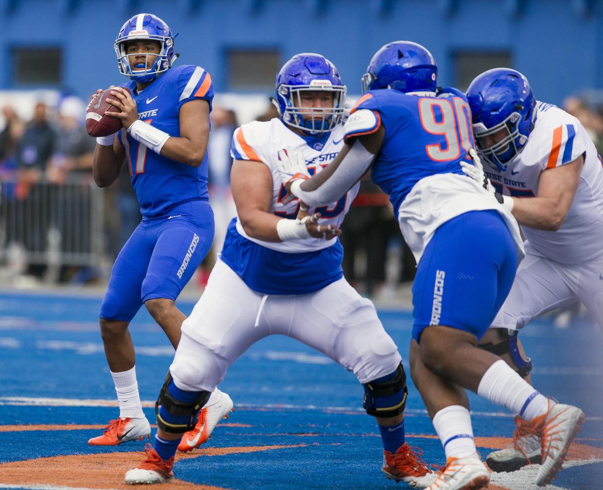 Boise State quarterback Zach Matlock gets pass protection from linemen Kekaniokoa Holomalia-Gonzalez (55) and Nick Crabtree against the rush of nose tackle Scale Igiehon during the Spring Game on April 6, 2019, at Albertsons Stadium in Boise.