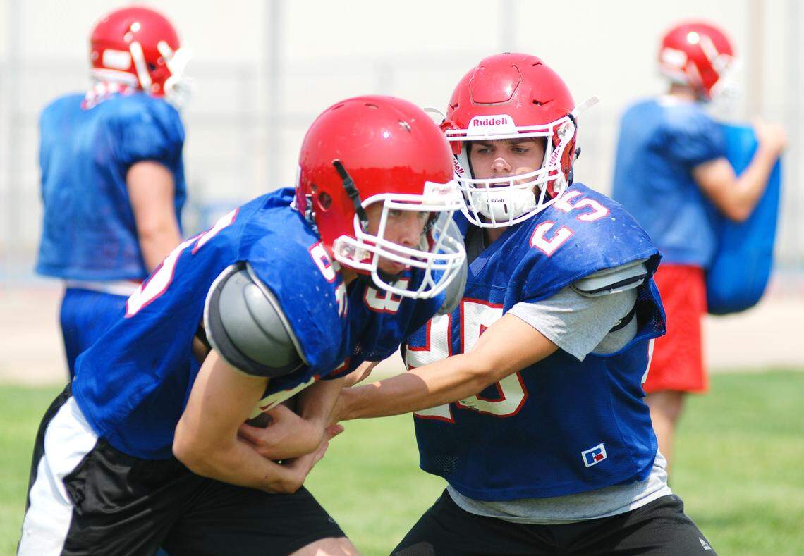 Braden Minor, right, returns for his second full season as Nampa’s starting quarterback.