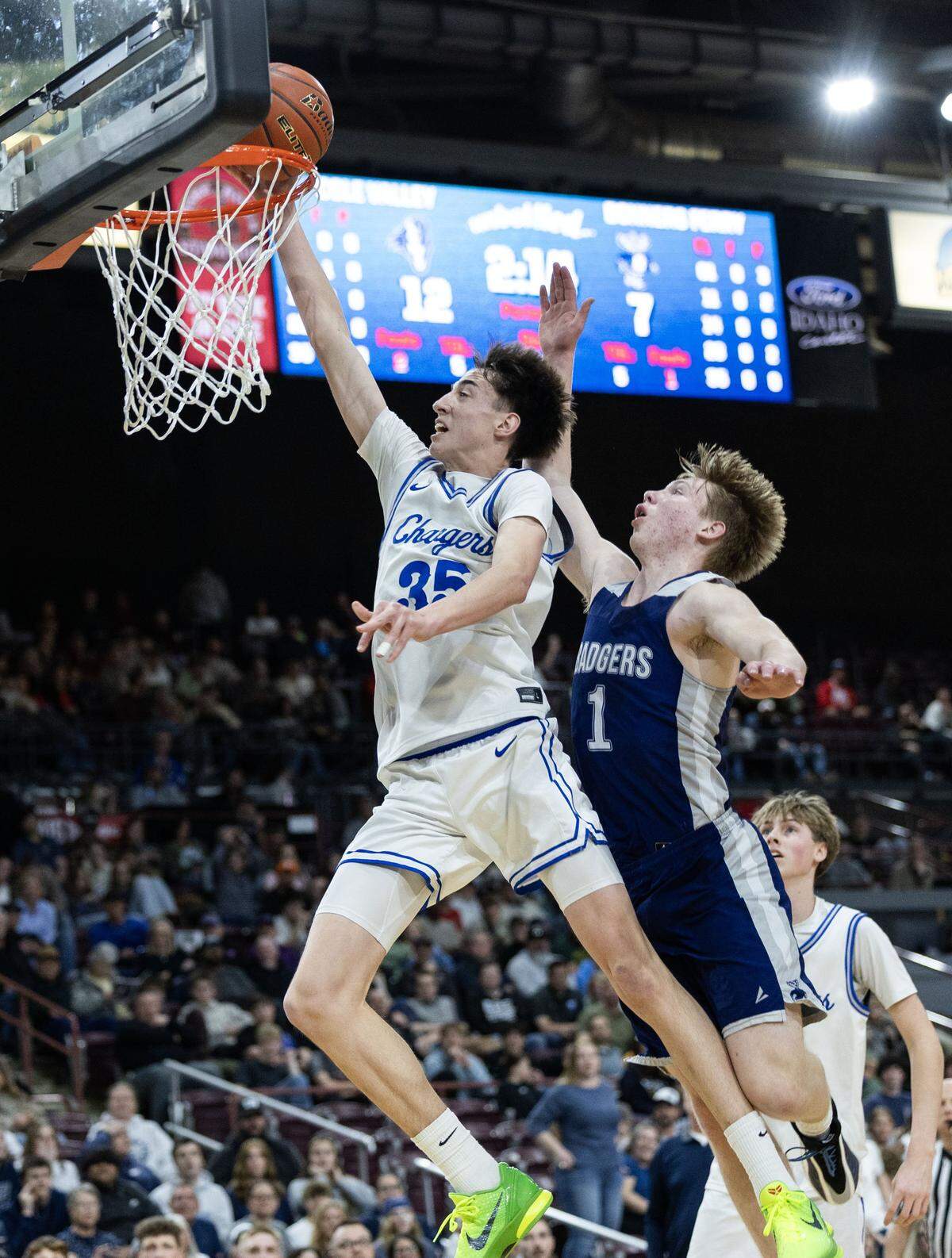 Cole Valley guard Soren Fraas drives and scores on Bonners Ferry's Ty Schrock in the 4A boys basketball state championship game at Ford Idaho Center in Nampa, Saturday, March 7, 2026.
