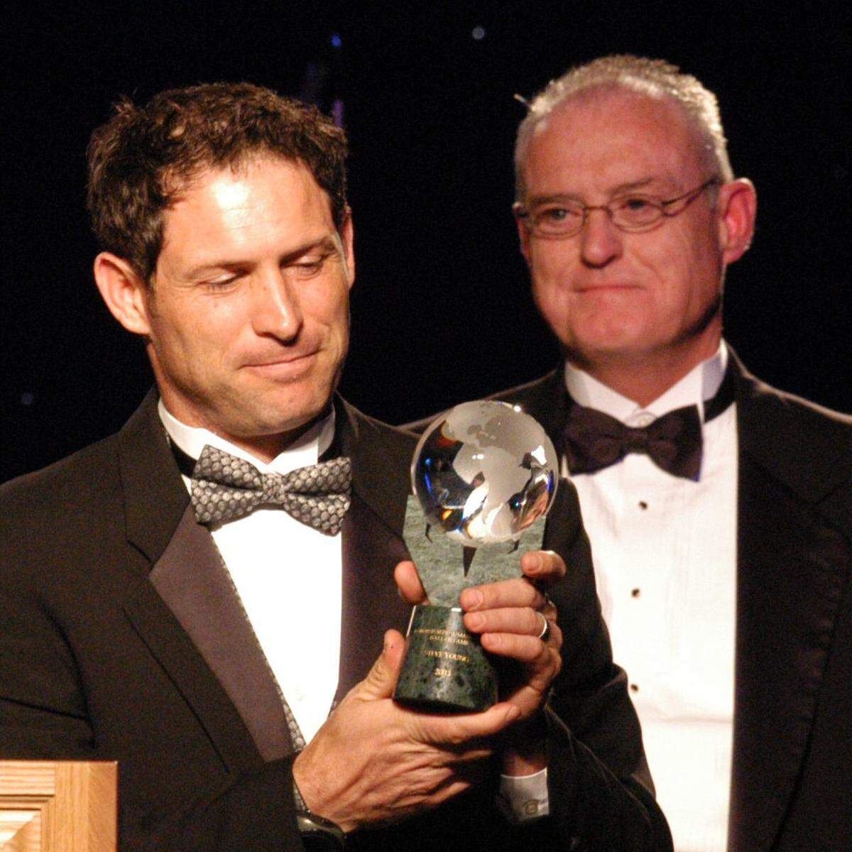 Honored for his achievements on and off the field, former NFL quarterback Steve Young, left, was inducted into the World Sports Humanitarian Hall of Fame in 2003.