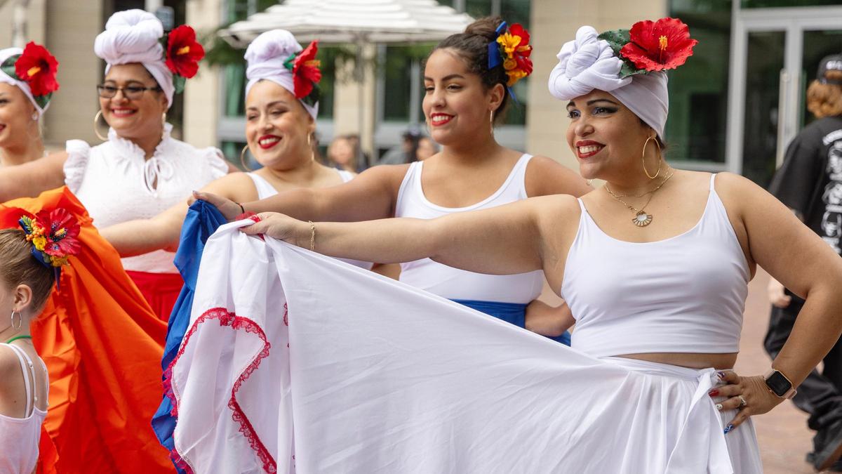 Ruby Padilla Roberts, at right, poses for a photo with her group Danza Boricua before the start of Latino Fest in downtown Boise. Danza Boricua performs Puerto Rican style dance.