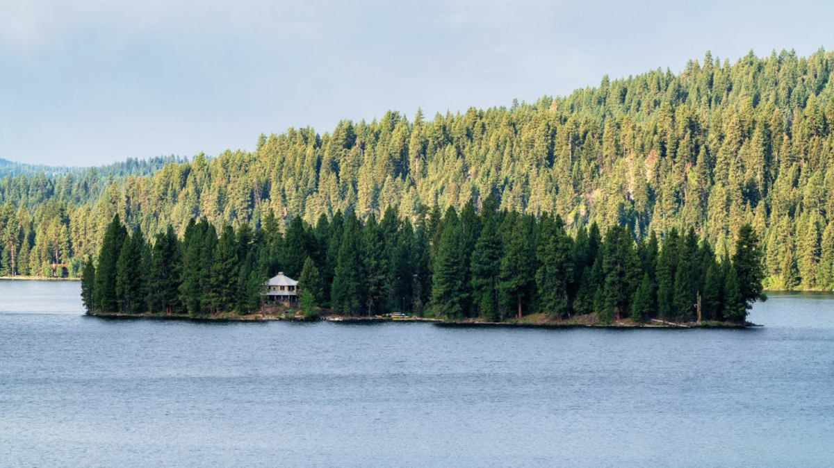 A photo from the Corbett Bottles auction catalog shows Cougar Island. The island was up for auction Wednesday, Sept. 14, 2022. The only bid was made on the parcel containing the home pictured here. The current lessee, Jim Laski, purchased the parcel and home.