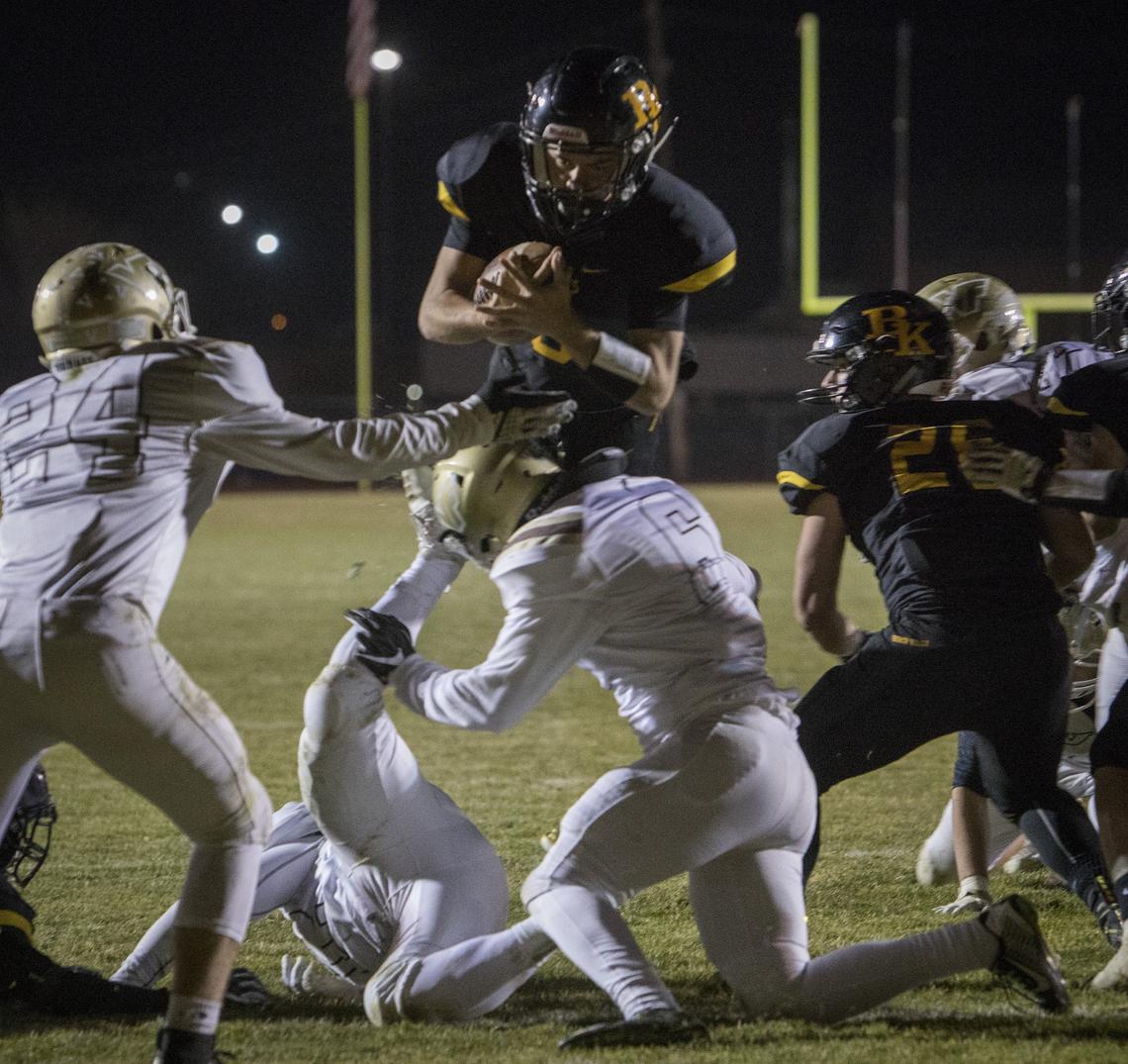 Brady King leaps over the Vallivue defense for a 1-yard touchdown run in the Bishop Kelly’s 34-27 win over Vallivue in 4A state semifinals Friday at Bishop Kelly High.