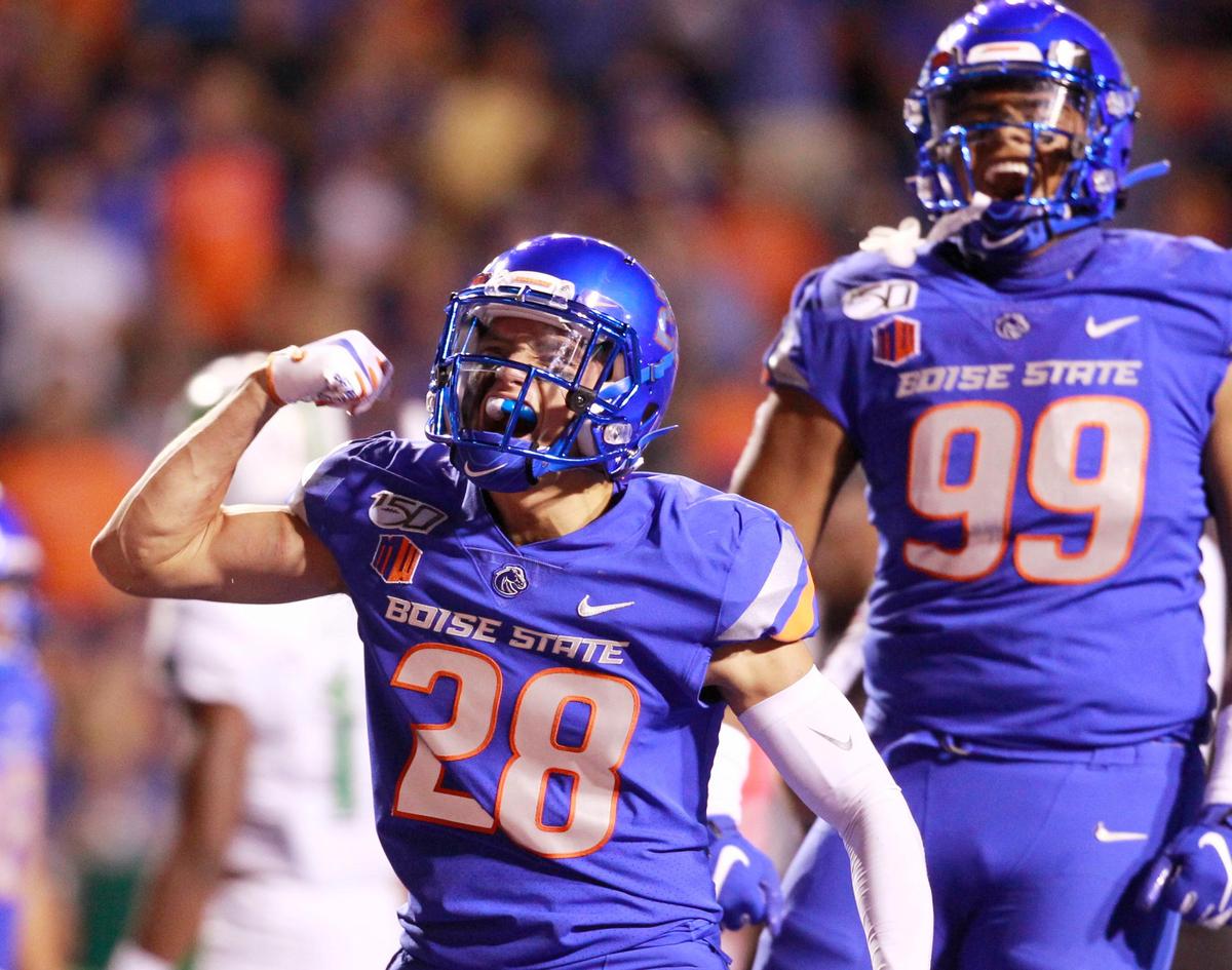 Boise State safety Kekaula Kaniho (28) celebrates his second-half quarterback knock-down with Boise State linebacker Curtis Weaver (99) in the Broncos’ home-opener on Friday Sept. 6th, 2019.
