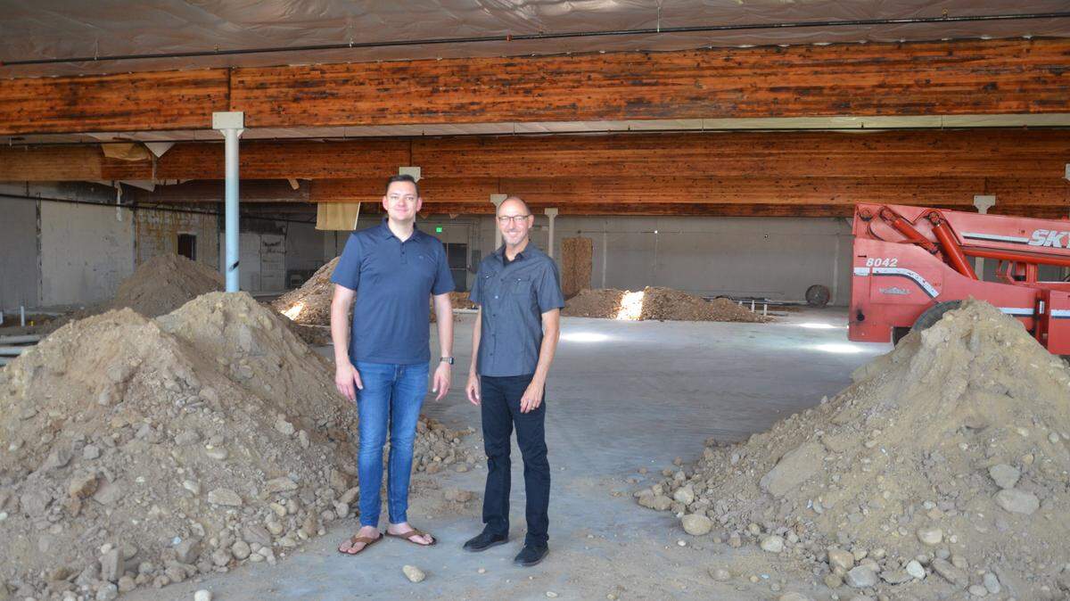 The Revs. Jordan Hodges, left, and Monty Sears of the Christian Faith Center stand inside what was once the Boise International Market. Black marks from the Sept. 5, 2015, fire that led to the market’s closure are visible on the beams above.