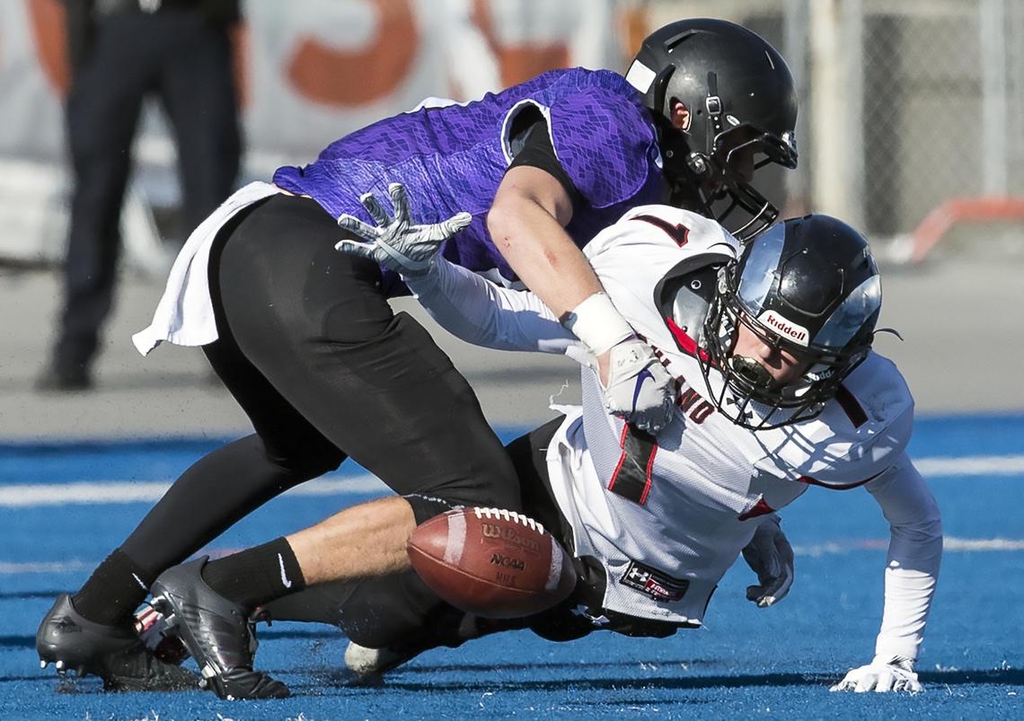 Rocky Mountain defensive back Jaxson Pabst hits Highland’s Andrew VanSickle after he fumbles the football in the fourth quarter of the state 5A championship.