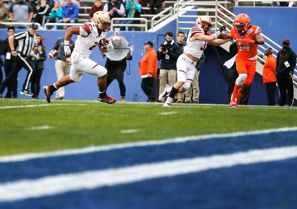 Boston College wide receiver Michael Walker blocks Boise State cornerback Tyler Horton as running back AJ Dillon runs the ball in for a touchdown during the SERVPRO First Responder Bowl on Wednesday, December 26, 2018, in Dallas.
