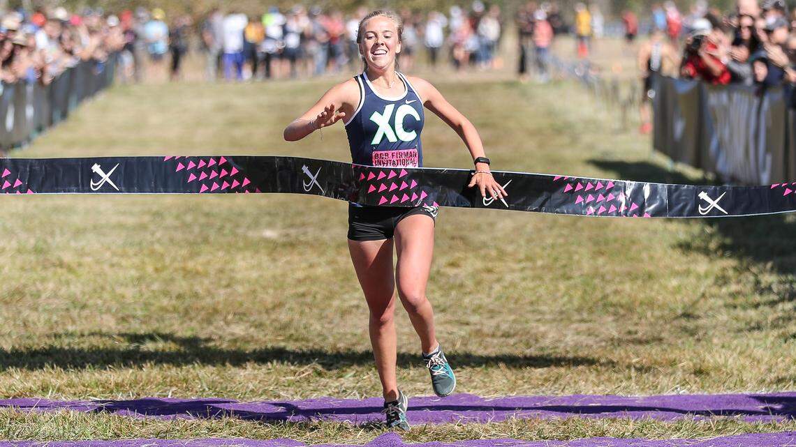 Lexy Halladay of Mountain View High School  crosses the finish line in 17:31.2 minutes to win the Elite Varsity Girls 5k race during the 2019 Bob Firman Invitational Cross Country meet Saturday at Eagle Island State Park. 