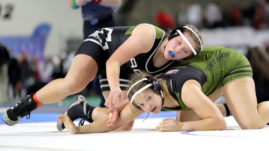Eagle teammates Reece Woods (bottom) and Jordynn LeBeau battle during the 182-pound girls wrestling state championship Saturday at Holt Arena in Pocatello. Woods pinned LeBeau in the third round after trailing the whole match.