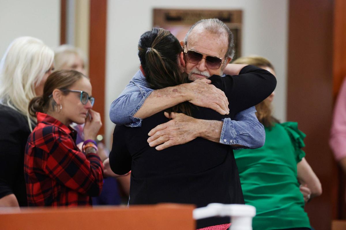 Larry Woodcock hugs someone after the jury convicted Chad Daybell of murdering his grandson JJ Vallow.