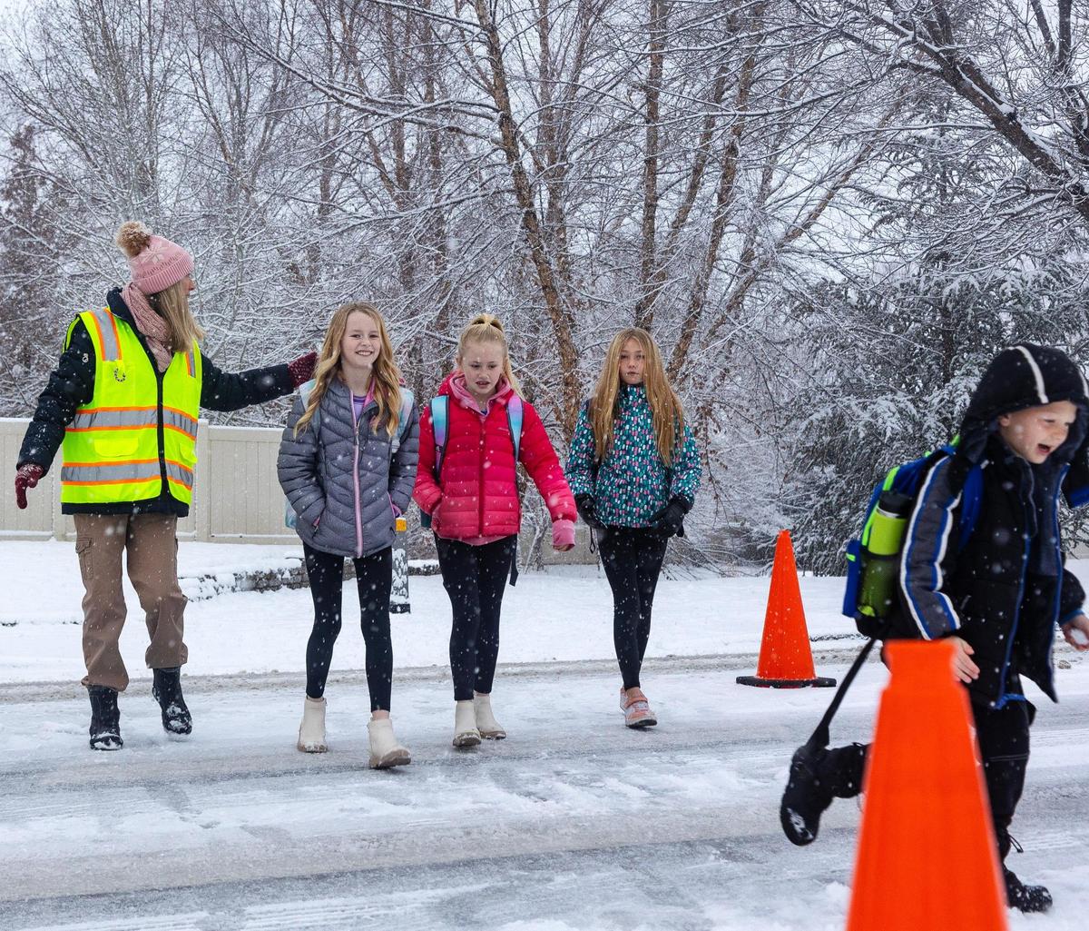 West Ada School District crossing guard Quinci Rushford stops traffic for students along a busy roadway before school Thursday at Siena Elementary School. With 40,000 students, the district is Idaho’s largest.