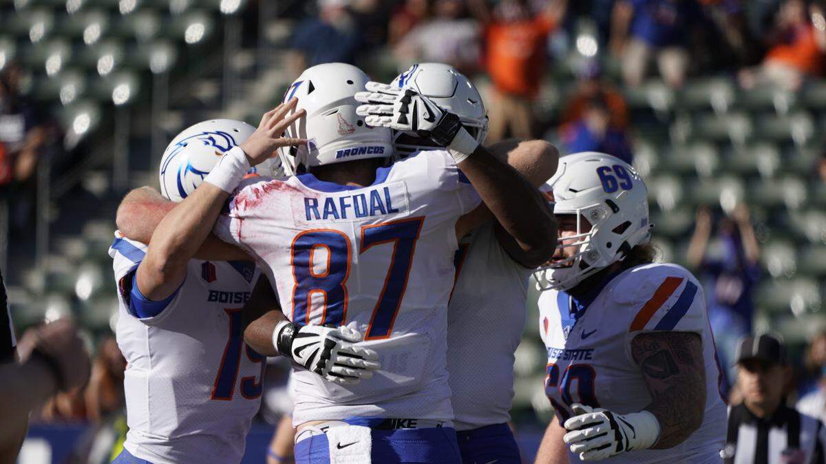 Boise State tight end Kurt Rafdal is congratulated by teammates after scoring on a 20-yard reception from Hank Bachmeier in the first quarter against No. 22 San Diego State.