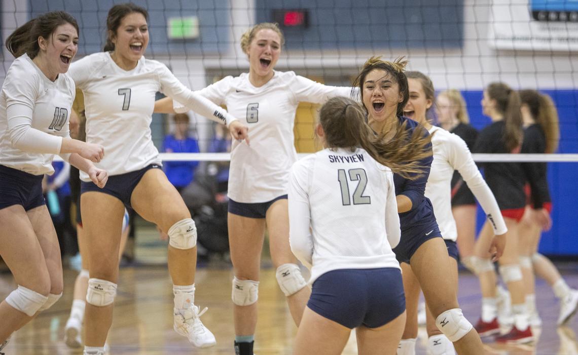 Skyview librero Ke’ilani Sedrick (in blue) and teammates celebrate as they clinch the 5A District Three volleyball championship over Boise on Thursday, Oct. 24, 2019. Both teams advance to the state tournament.