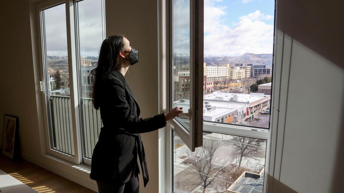 Megan Ishizu, community manager for Roundhouse properties, opens an eighth floor apartment window at Hearth On Broad, which will open soon in Downtown Boise. Roundhouse also built nearby The Fowler apartments along Myrtle Street.