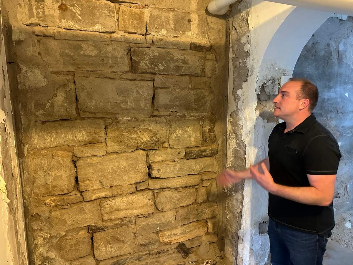 Dan Everhart, Idaho State Historic Preservation Office outreach historian, explains the damage that’s been done to the walls in the basement of the Assay Office building, 210 W. Main St., Boise. A $1.5 million project will repair and protect the walls and remodel parts of the basement for staff use.