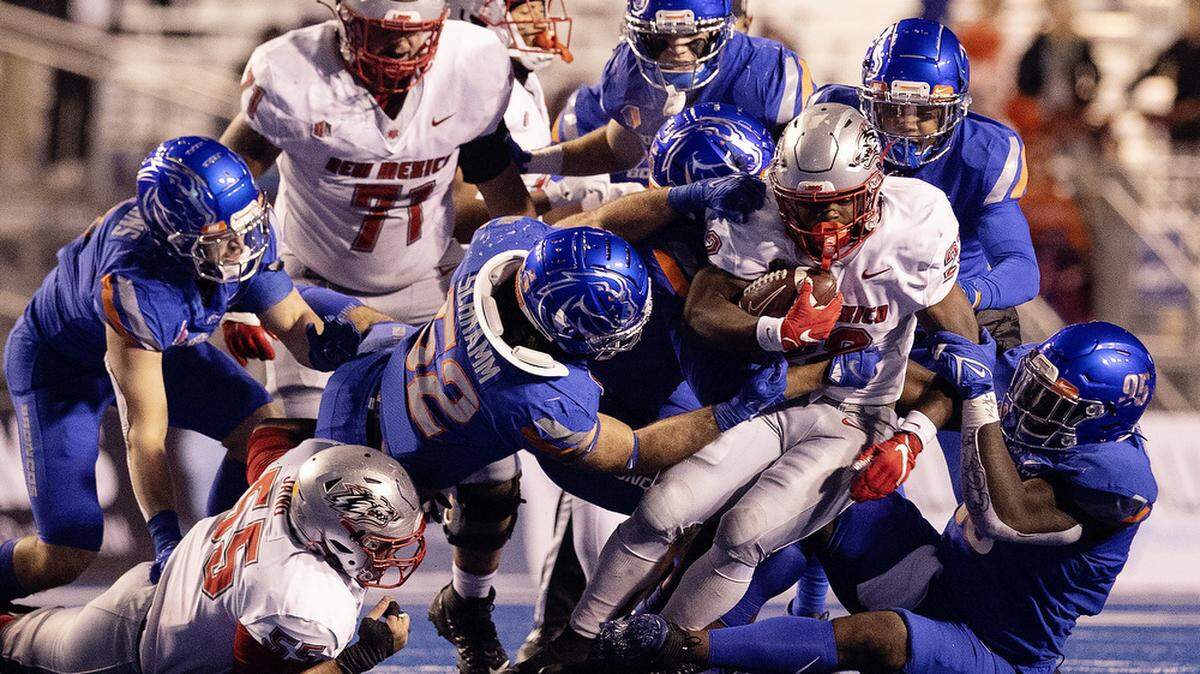 A host of Broncos take down New Mexico running back Aaron Dumas in the second half of their game against New Mexico on Saturday Nov. 20, 2021 at Albertsons Stadium in this file photo.