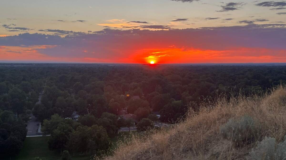 The sun setting over Boise from Camel’s Back Park in Boise on Aug. 20, 2022.