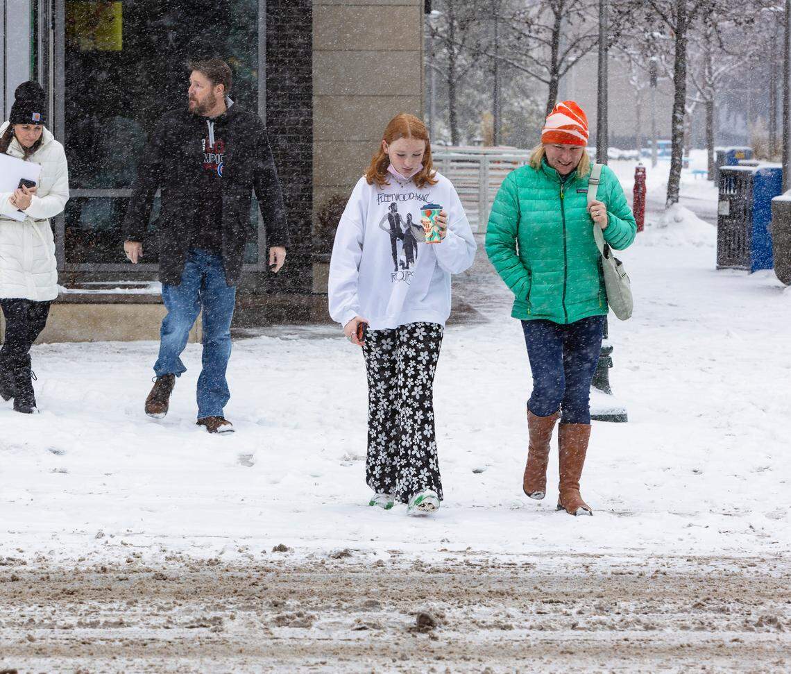 Lily Tetrick, 13, and her mother Amber Tetrick cross Main Street in the snow in downtown Boise on Wednesday, Dec. 29, 2021. The National Weather Service is forecasting very cold temperatures in the Treasure Valley from Friday night through Sunday. Snow will continue on Thursday.