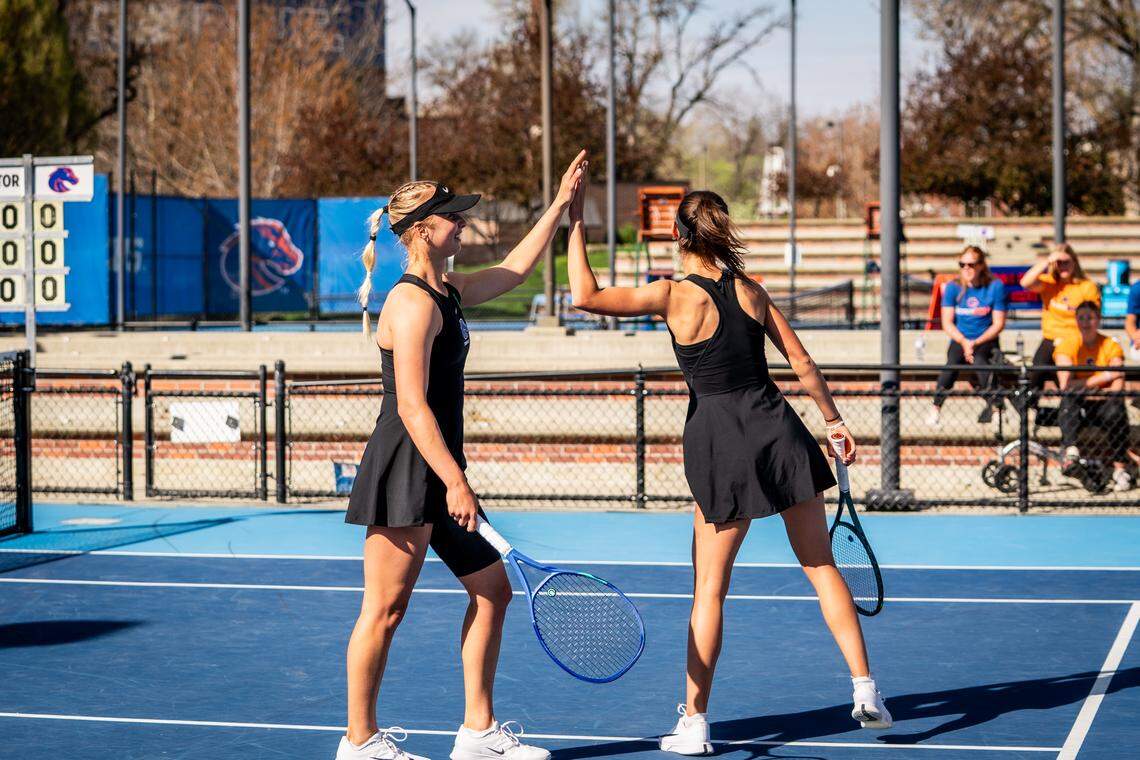 Boise State junior Zdena Safarova, left, high-fives doubles teammate Tereza Polakova in a match against UNLV. The Broncos, Rebels and San Diego State tied for the Mountain West regular season title.