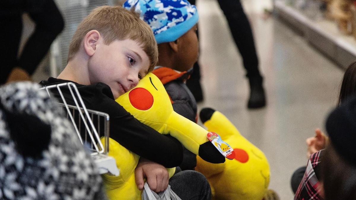 Matthew Smith, 8, hugs the large Pikachu stuffed animal he bought during the Boise Parks and Recreation Department’s Annual Kids Holiday Shopping Spree at Target, 6280 N. Eagle Rd., on Dec. 21, 2022. Fifty volunteers chaperoned 172 students at the store in three time blocks Wednesday afternoon. Each child had $40 to spend.
