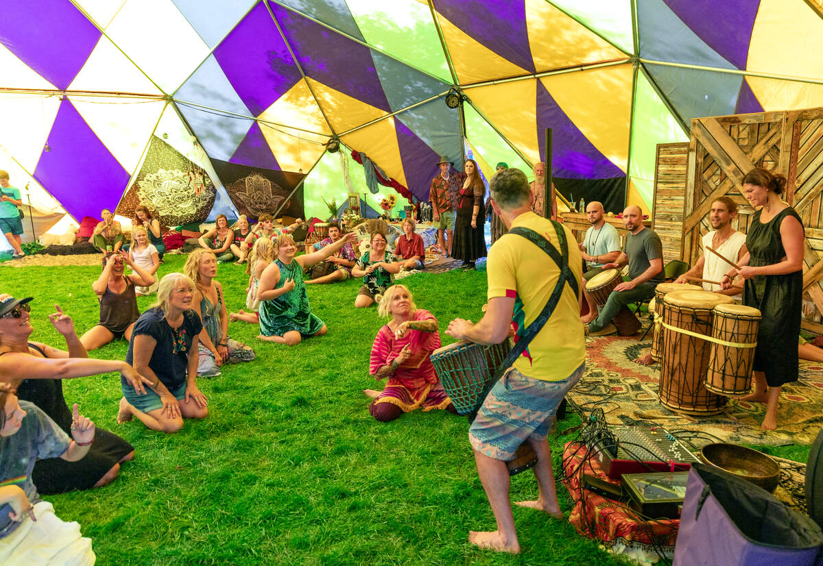People dance to the beat of African-style drums inside a geodesic dome during the Hyde Park Street Fair.