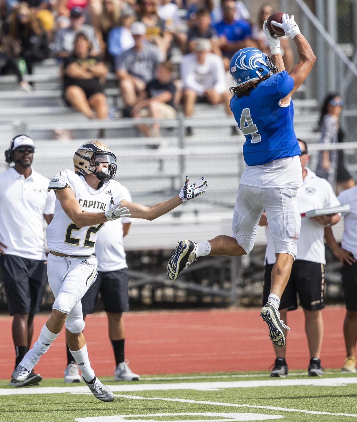 Timberline defensive back Sam Rodenbaugh intercepts a pass intended to Capital’s Hayden Picard earlier this season at Dona Larsen Park.