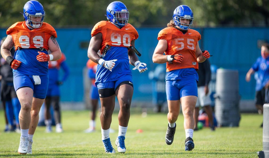 Boise State defensive linemen Scott Matlock (99), Scale Igiehon (90) and Shane Irwin (55) run drills during fall camp.