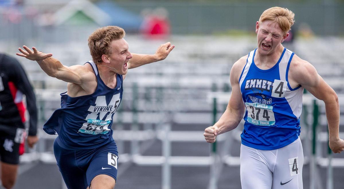 Emmett’s Landon Helms, right, screams past a lunging Mason Nichols of Middleton for the 4A 110 hurdles state title last spring.