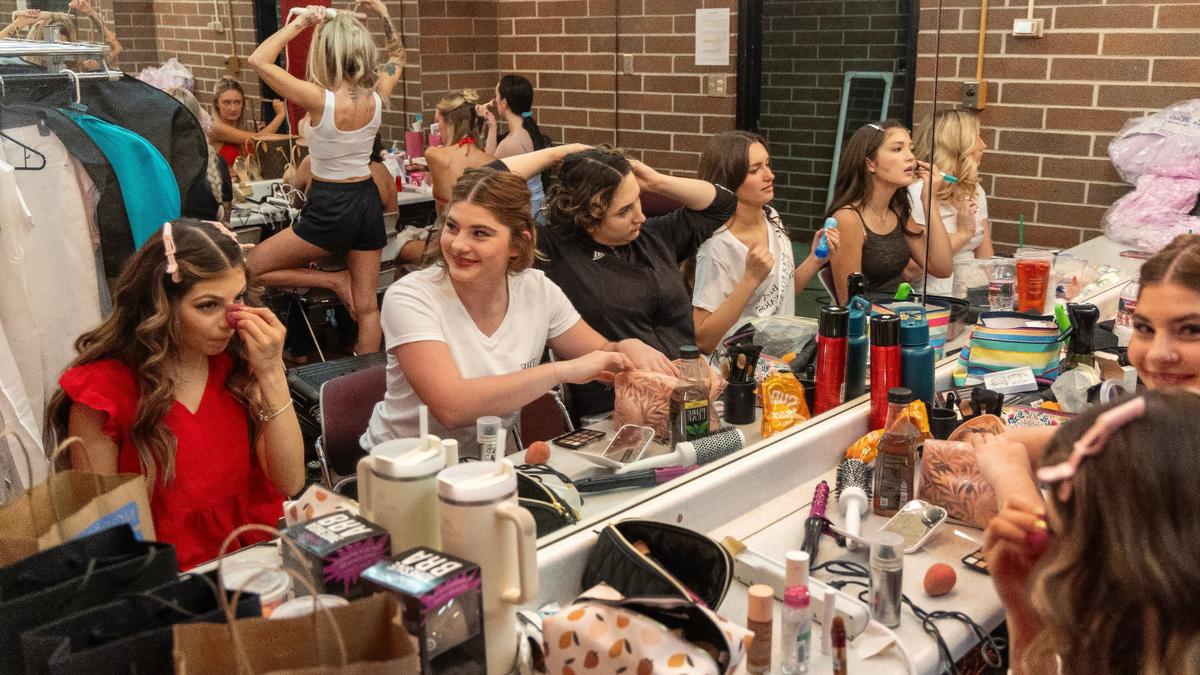 Miss Idaho Teen USA contestants do their hair and makeup backstage during the pageant.