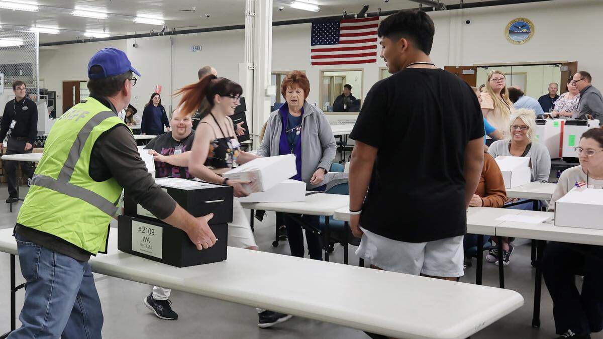 Once inside the Elections Office, each precinct’s supplies are divided up and sent to different stations for processing.