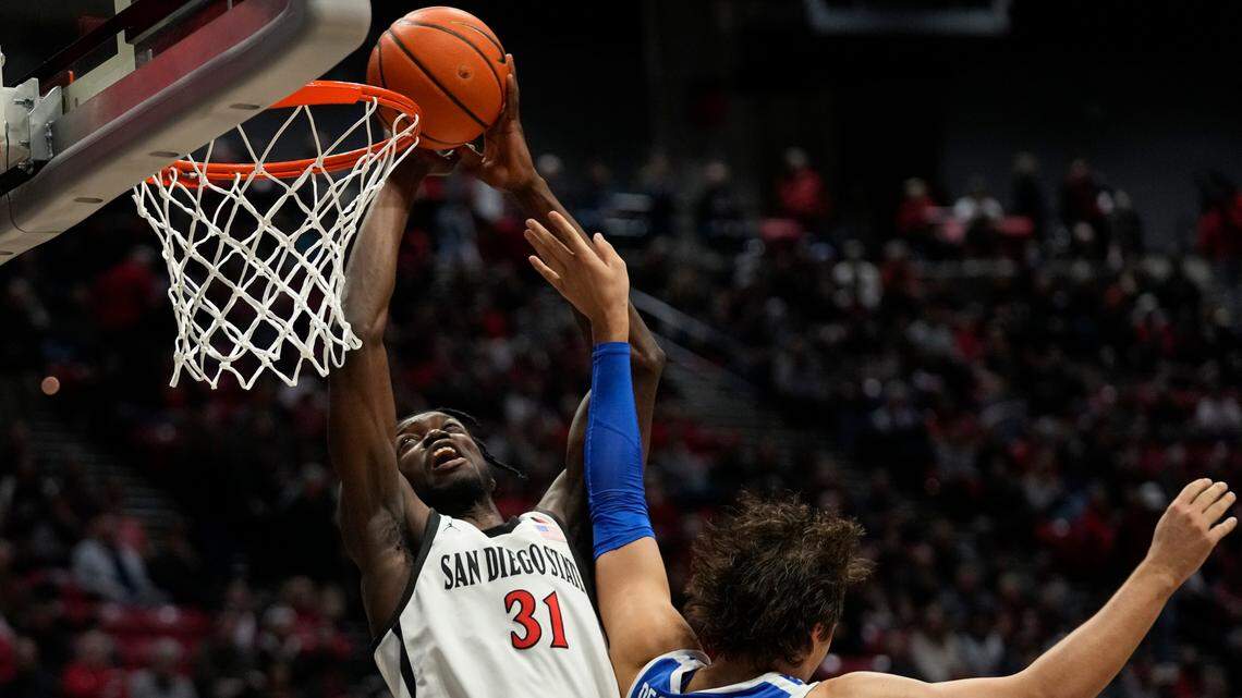 San Diego State forward Nathan Mensah shoots as Boise State forward Tyson Degenhart defends during the first half Friday in San Diego.