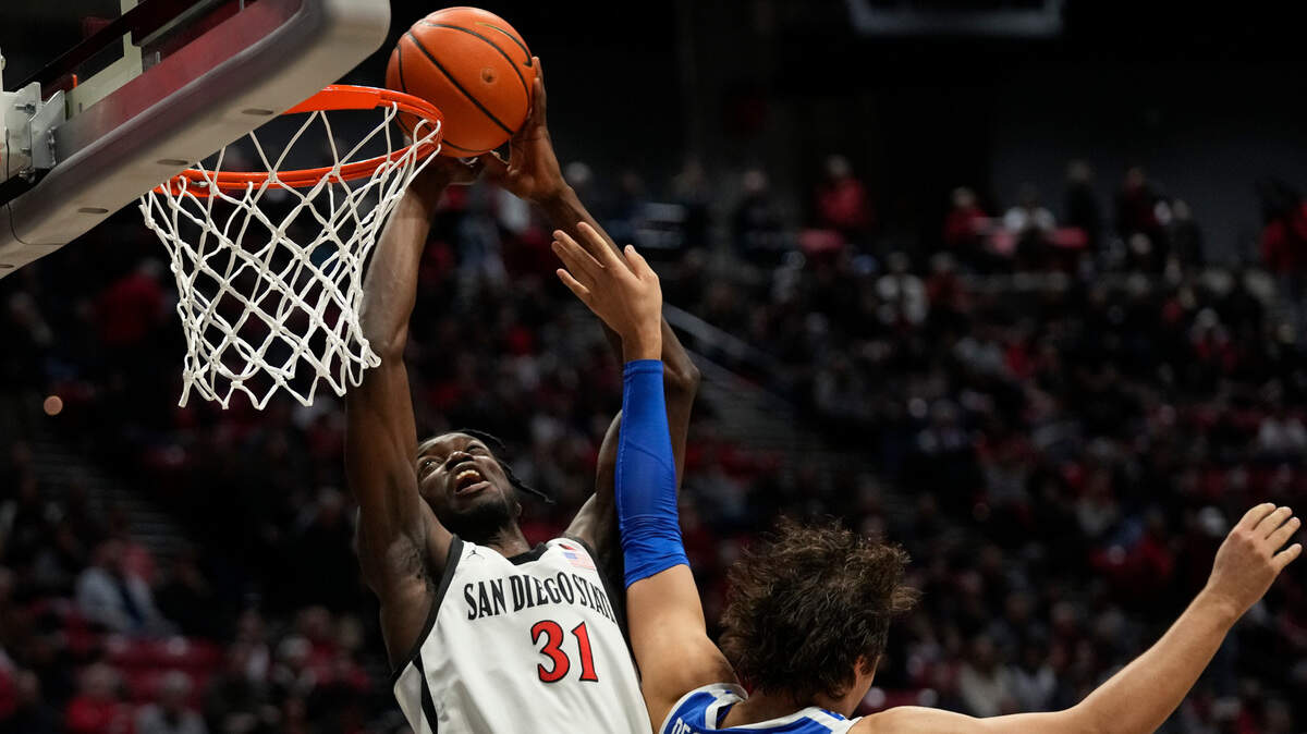 San Diego State forward Nathan Mensah shoots as Boise State forward Tyson Degenhart defends during the first half Friday in San Diego.
