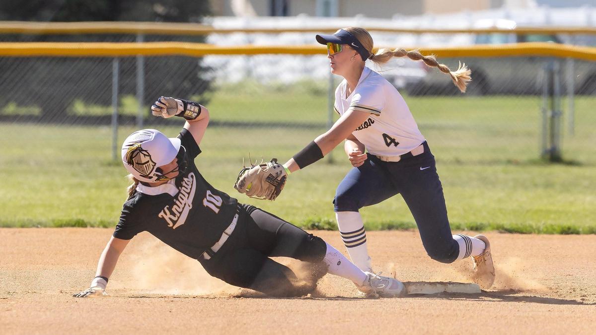 Bishop Kelly’s Kingsley Shea makes if safely back to first base before the tag from Middleton’s Sadie Stafford on Thursday.