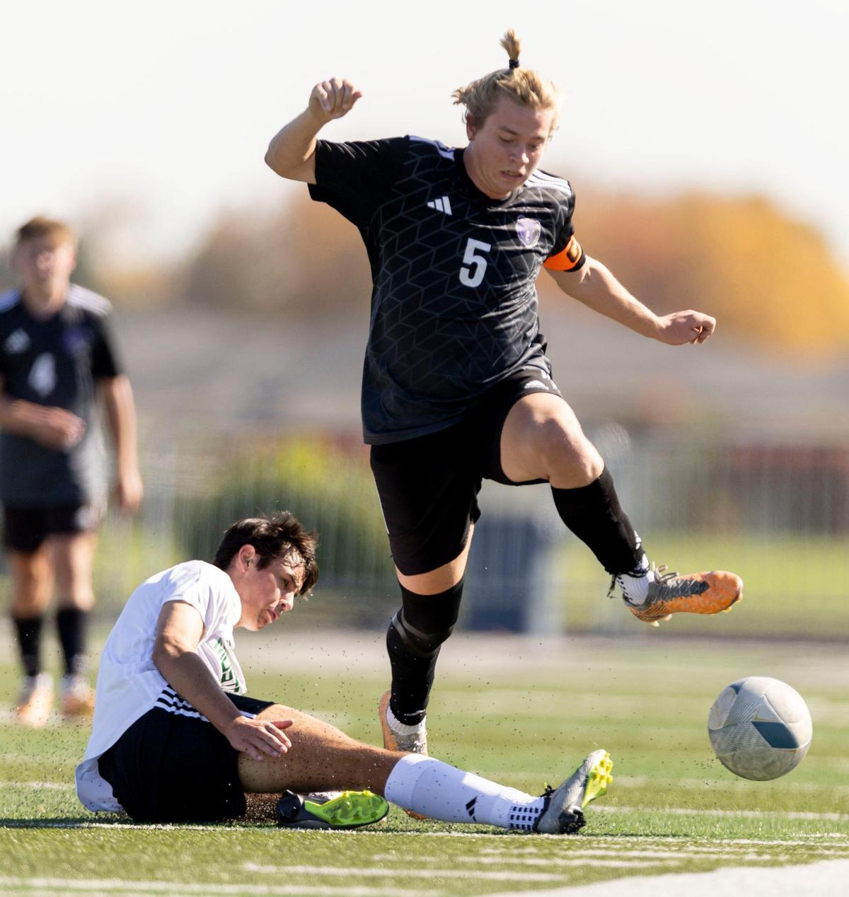 Eagle midfielder Lucas Boockholdt makes a sliding tackle during last year’s state semifinals.