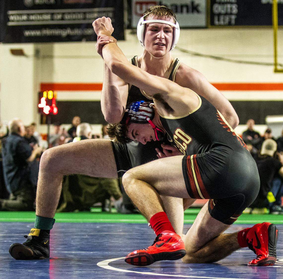 Kuna senior Cedar Miller holds off Minico sophomore Tazyn Twiss in their 4A 170-pound championship match Saturday, Feb. 23, 2019, during the State Wrestling Championships at Holt Arena in Pocatello. Miller defeated Twiss 3-2 to claim the state title.
