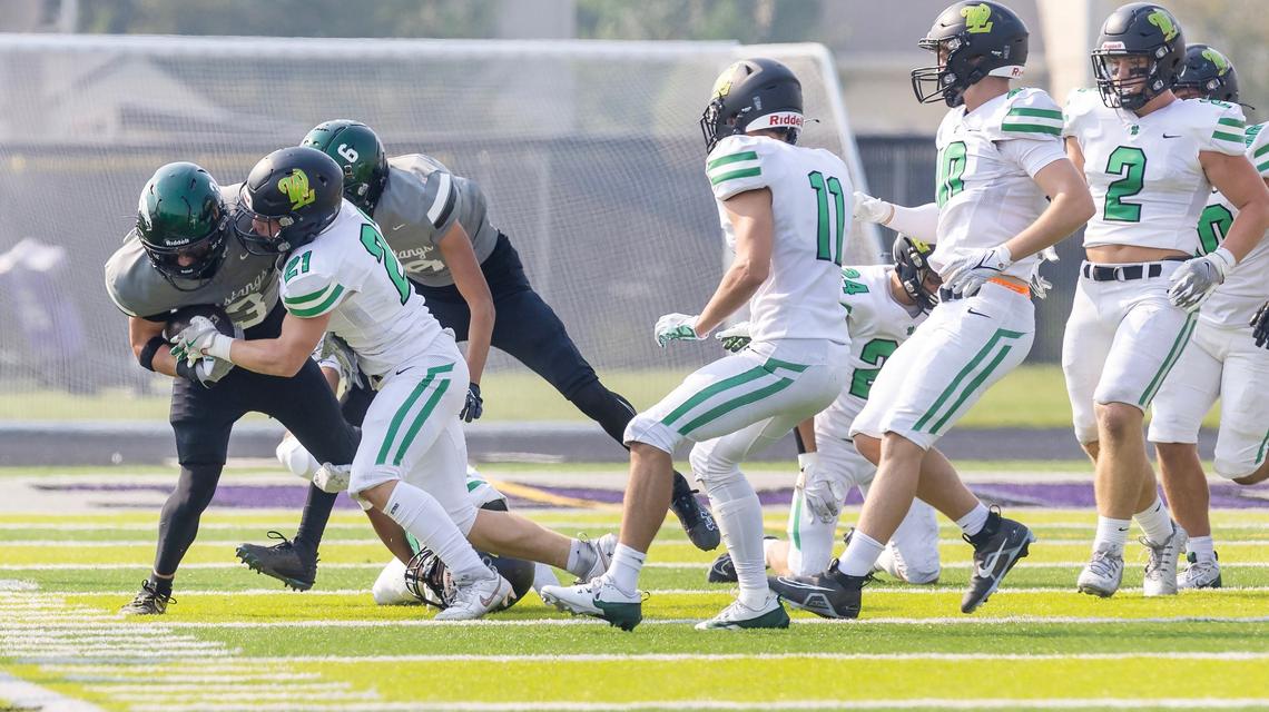 Eagle running back Noah Burnham is pushed out of bounds by West Linn safety Shane Peters on Saturday.