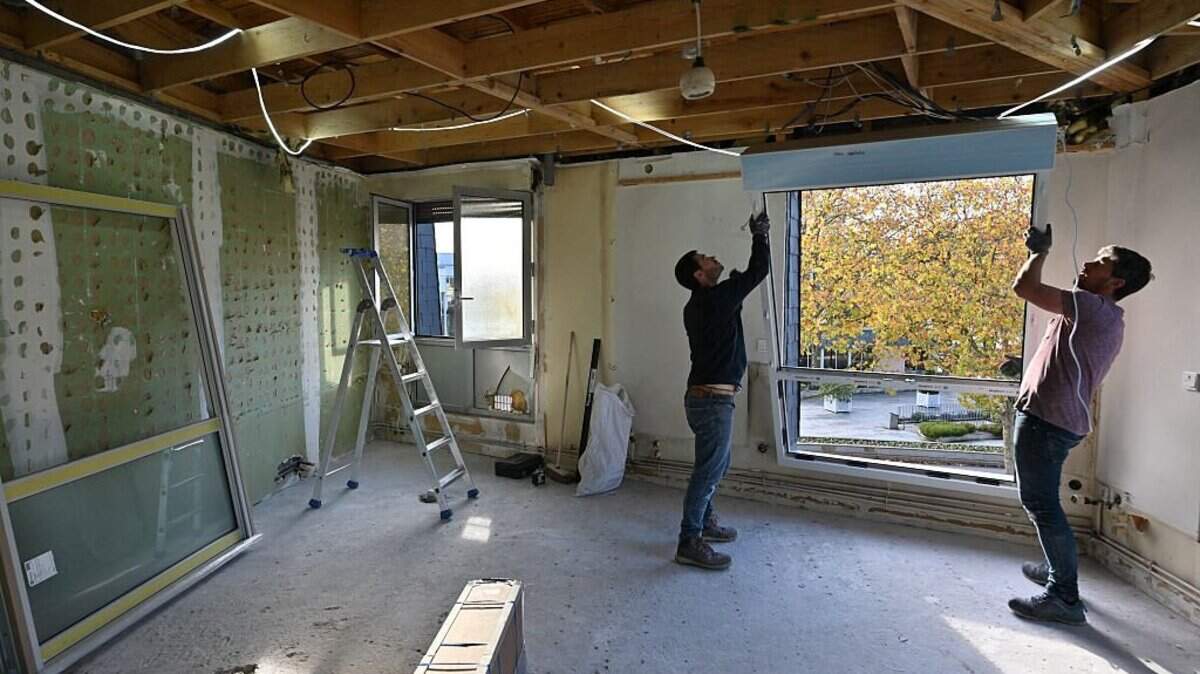 View of an apartment under renovation. Two workers are carrying a window to install it, in France, on November 1, 2025. Illustration of interior renovation of an apartment in France, on November 1, 2025. (Photo by Henrique Campos / Hans Lucas via AFP) (Photo by HENRIQUE CAMPOS/Hans Lucas/AFP via Getty Images)          