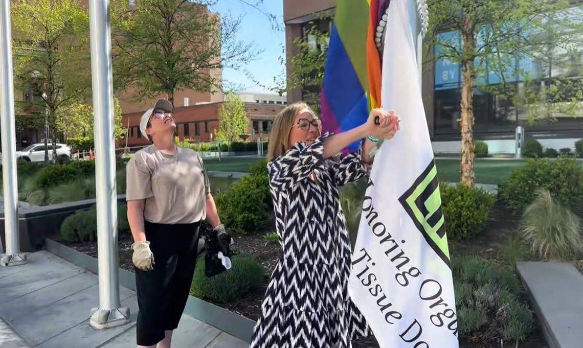 This photo, taken from a video shared with the Idaho Statesman, shows Boise Mayor Lauren McLean putting Pride and Donate Life flags back up in front of City Hall on Easter Sunday after activists covered them.